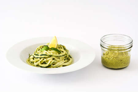 Zucchini noodles with pesto sauce isolated on white backgroundの写真素材