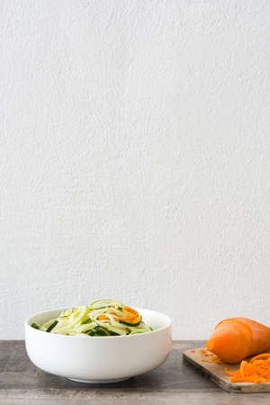 Carrot and zucchini noodles on wooden tableの写真素材