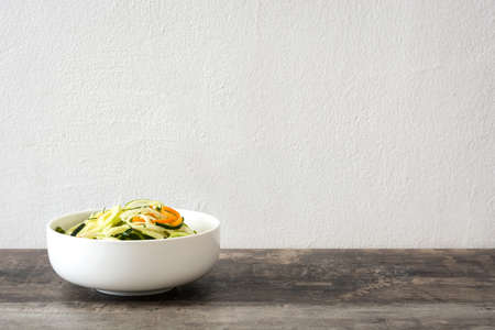 Carrot and zucchini noodles on wooden tableの写真素材