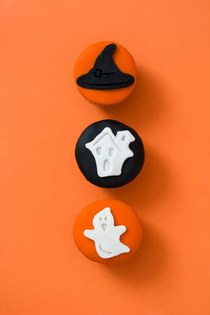 Halloween cupcakes on orange background