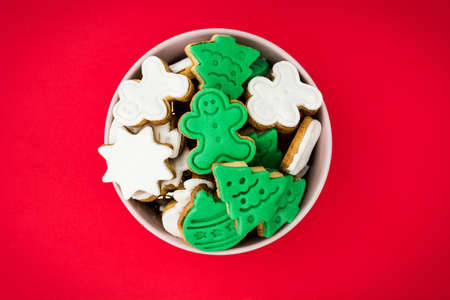 Christmas cookies in a bowl on red background