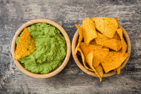 Guacamole With nachos on wooden backgroundの写真素材