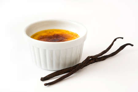 Creme brulee and vanilla pods, isolated on white background.
