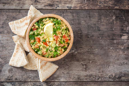 Tabbouleh salad with couscous on rustic tableの写真素材