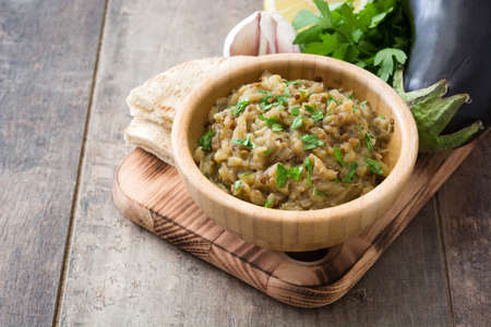 Baba Ganoush and ingredients on wooden tableの写真素材