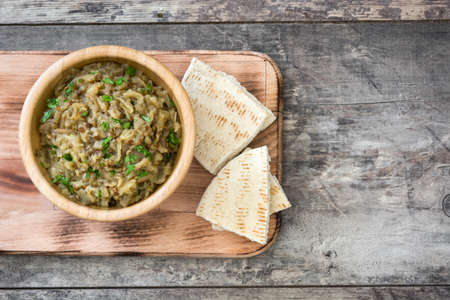 Eggplant and baba ganoush pita bread on wooden tableの写真素材