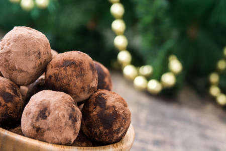 Christmas chocolate truffles and Christmas decoration on wooden tableの写真素材