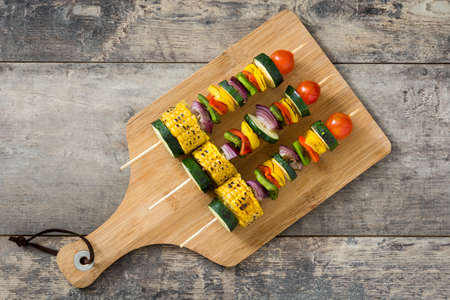 Vegetable skewers on wooden tableの写真素材