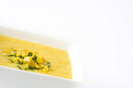 Corn soup in white bowl isolated on white background