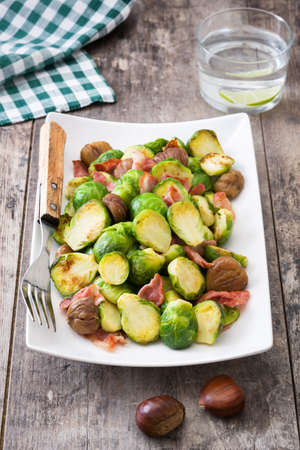 With chestnuts and Brussels sprouts bacon on wooden tableの写真素材