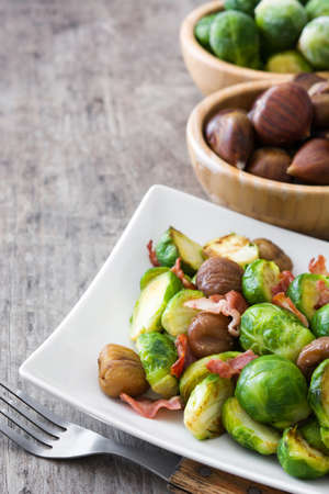 With chestnuts and Brussels sprouts bacon on wooden tableの写真素材