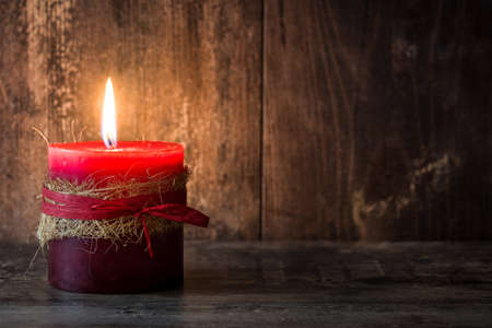 Red Christmas candle on wooden tableの写真素材