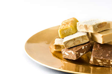 Christmas nougat on a golden plate isolated on white backgroundの写真素材
