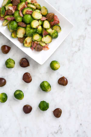 With chestnuts and Brussels sprouts bacon on white marbleの写真素材