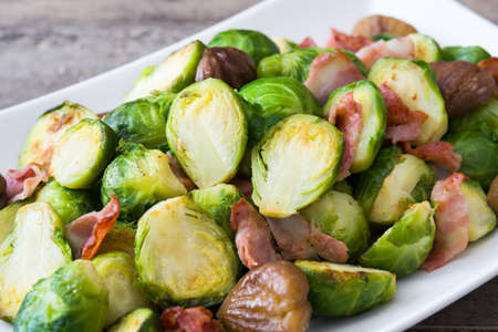 With chestnuts and Brussels sprouts bacon on wooden backgroundの写真素材