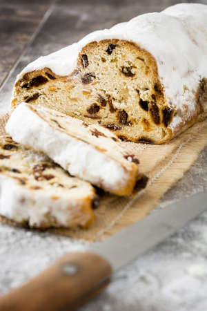 Christmas stollen. Traditional German Christmas dessert on wooden backgroundの写真素材