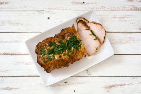 Roasted pork on white wooden tableの写真素材