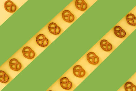 Pretzel on yellow and green backgroundの写真素材