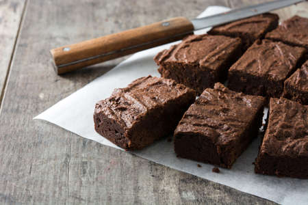 Chocolate brownie portions on wooden backgroundの写真素材