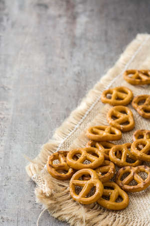 Salted pretzels on wooden background