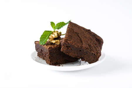 Chocolate brownie pieces isolated on white backgroundの写真素材