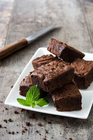 Chocolate brownie pieces on wooden backgroundの写真素材