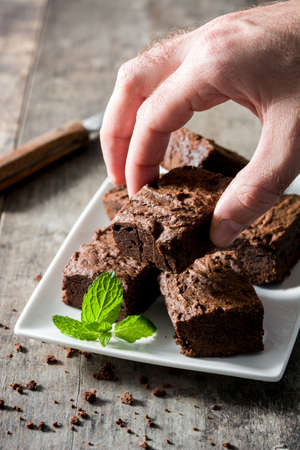 Man catching a brownie pieceの写真素材