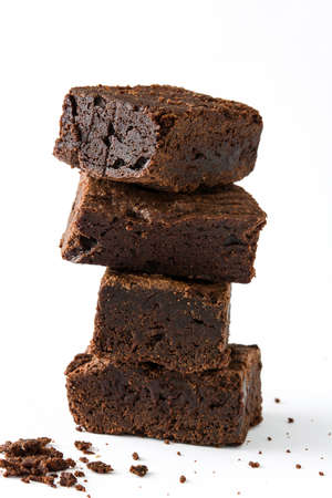 Chocolate brownie pieces isolated on white backgroundの写真素材