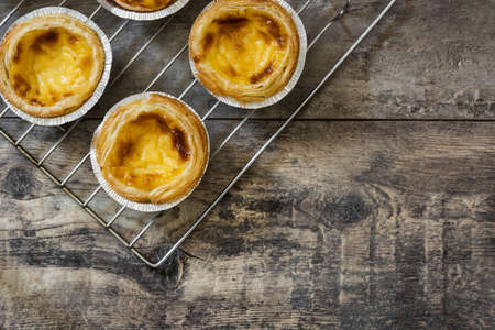 Pasteis de nata. Typical Portuguese egg custard tart on wooden background