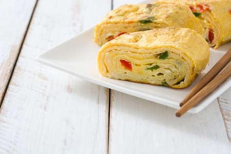 Tamagoyaki Traditional Japanese omelette on white wooden table.の写真素材