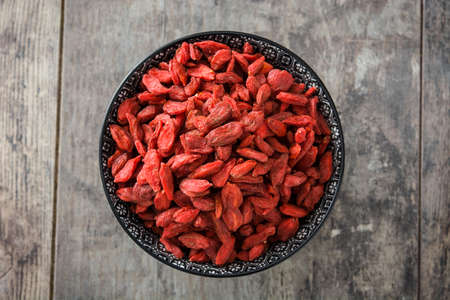Or wolfberries Goji berries in bowl on wooden backgroundの写真素材