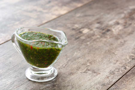 Green Chimichurri Sauce on wooden table.Copyspaceの写真素材