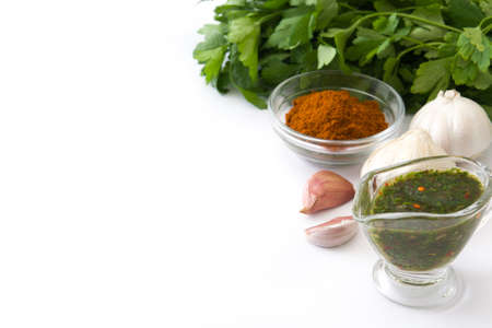 Green Chimichurri Sauce and ingredients isolated on white backgroundの写真素材
