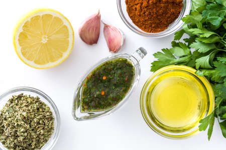 Green Chimichurri Sauce and ingredients isolated on white background.Top viewの写真素材
