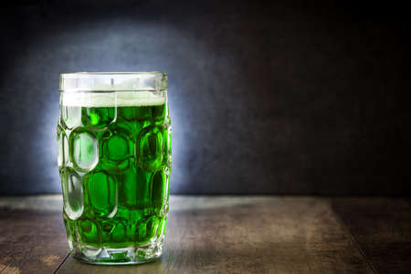 Traditional cold green beer for Saint Patrick's Day on wooden table. Copyspace.の写真素材