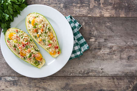 With stuffed zucchini quinoa and vegetables on wooden backgroundの写真素材