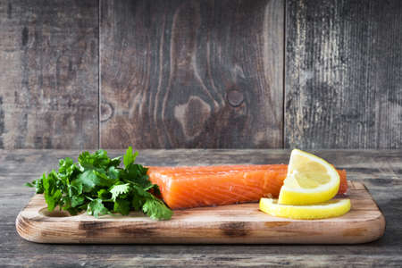 Raw salmon fillet on wooden backgroundの写真素材