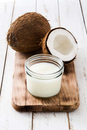 Coconut and coconut milk on white wooden table