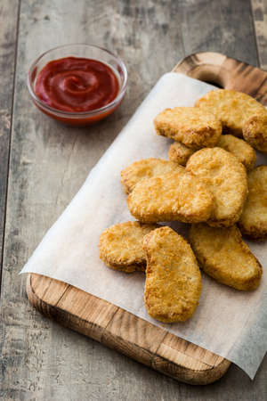 Fried chicken nuggets on wooden tableの写真素材