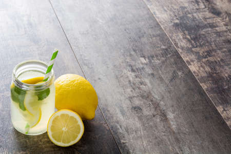 Lemonade drink in glass jar on a wooden background. Copyspace.の写真素材