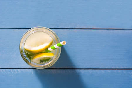 Lemonade drink in glass jar on a wooden blue background. Copyspace.Top viewの写真素材