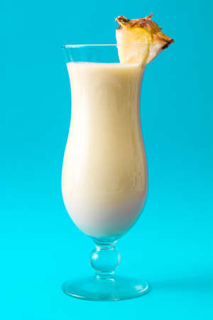 pina colada cocktail on blue background