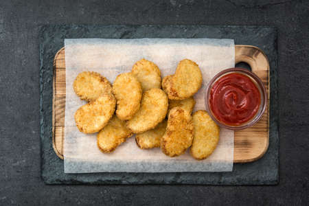 Fried chicken nuggets on black slateの写真素材