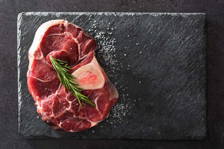 Raw meat on black slate top view.Copyspaceの写真素材