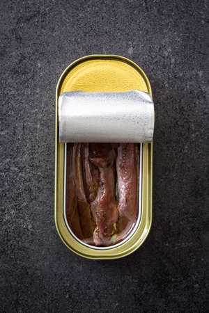 Anchovies can on slate backgroundの写真素材