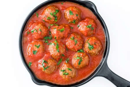 Meatballs with tomato sauce in iron frying pan isolated on white background. Top viewの写真素材