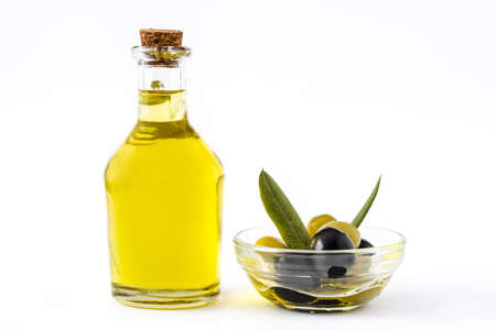Virgin olive oil in a crystal bottle isolated on white backgroundの写真素材