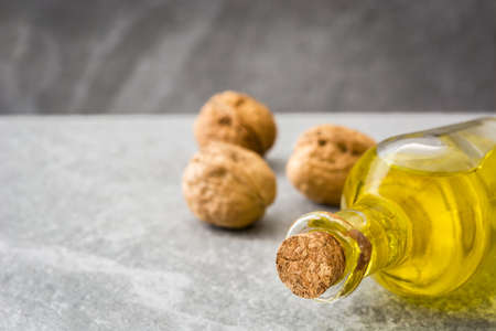 Walnuts oil on gray stone. copyspaceの写真素材