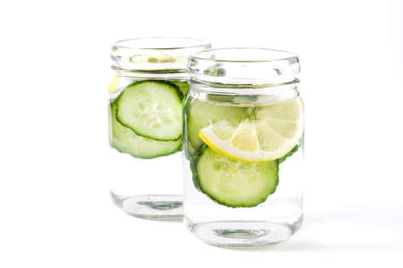 Detox water with cucumber and lemon isolated on white backgroundの写真素材