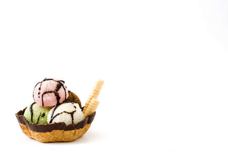 Ice cream scoops served in waffle basket isolated on white backgroundの写真素材